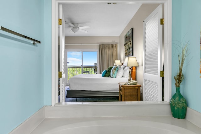 bedroom featuring ceiling fan and access to exterior