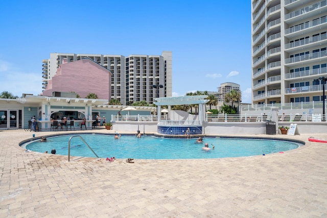 view of swimming pool featuring a patio area and a pergola