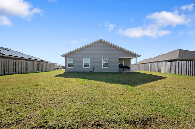 back of house featuring a yard