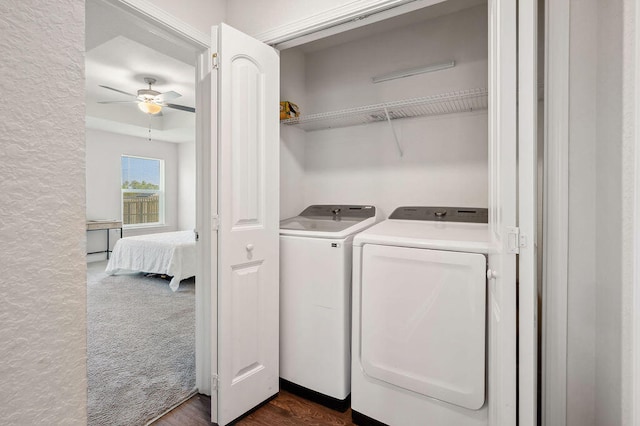 laundry area featuring dark wood-type flooring, washer and dryer, and ceiling fan