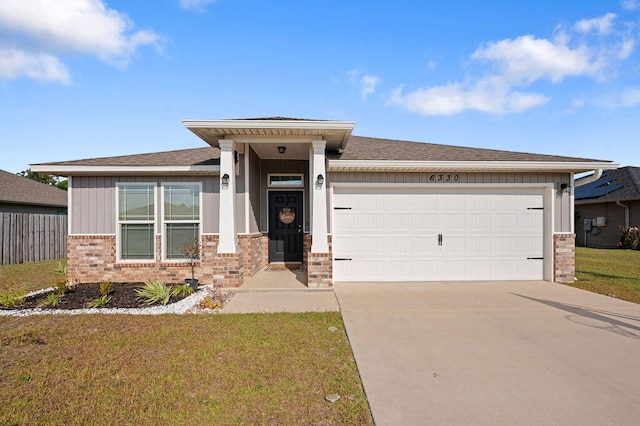 view of front of home with a front yard and a garage