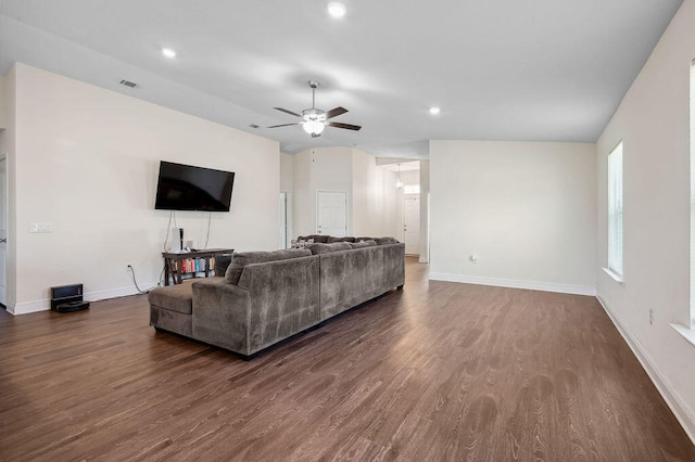 living room with ceiling fan and dark hardwood / wood-style flooring