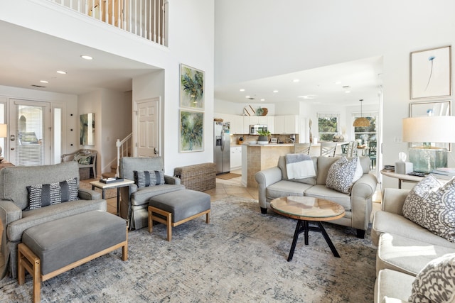 living room with recessed lighting, a towering ceiling, and a wealth of natural light