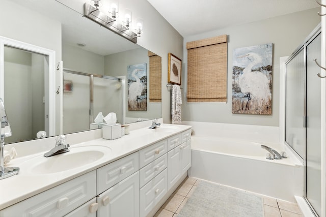 bathroom featuring a sink, double vanity, tile patterned floors, a bath, and a stall shower