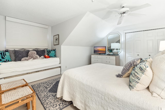 bedroom with carpet floors, ceiling fan, lofted ceiling, and a closet