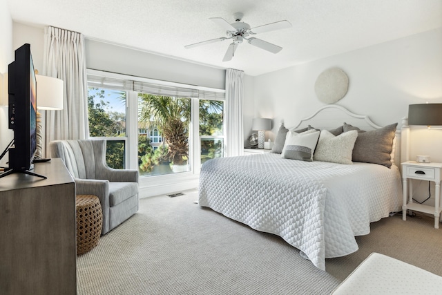 bedroom featuring a ceiling fan, carpet flooring, and visible vents
