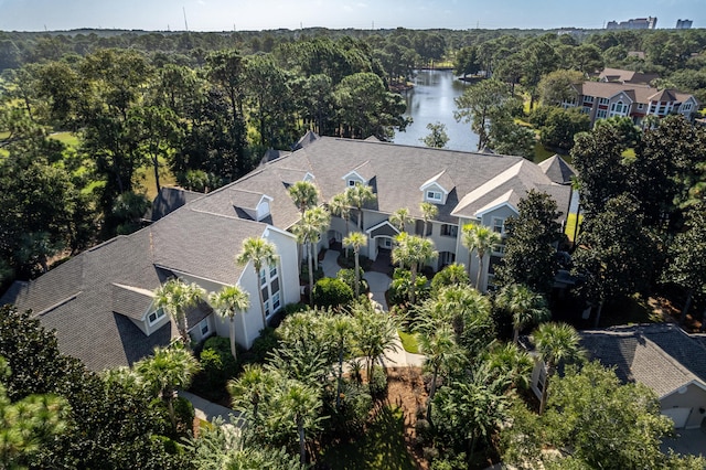drone / aerial view with a water view and a wooded view