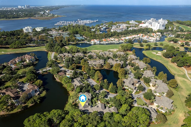 drone / aerial view with a water view, golf course view, and a residential view