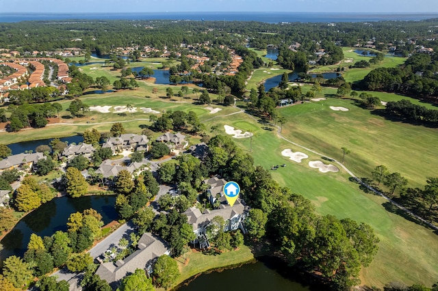 drone / aerial view featuring a water view, golf course view, and a residential view