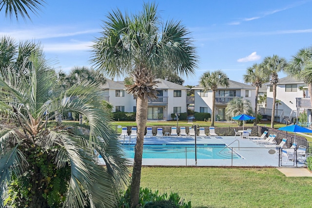 view of swimming pool featuring a patio area and a lawn