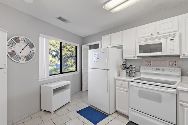 kitchen with white cabinets and white appliances