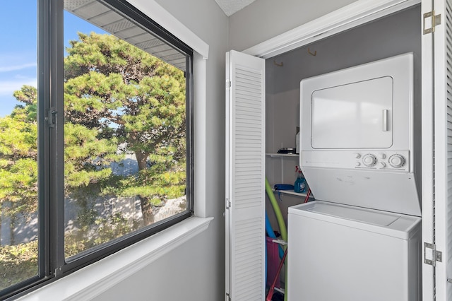 laundry room featuring stacked washer and dryer