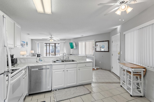 285 Payne St Unit 20B, Miramar Beach, FL 32550 - kitchen featuring dishwasher, white electric range, ceiling fan, a sink, and a peninsula