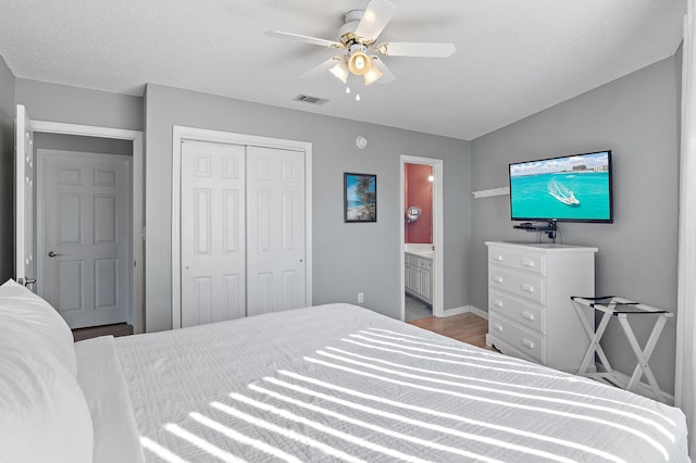 285 Payne St Unit 20B, Miramar Beach, FL 32550 - bedroom with a closet, a ceiling fan, ensuite bathroom, wood finished floors, and baseboards