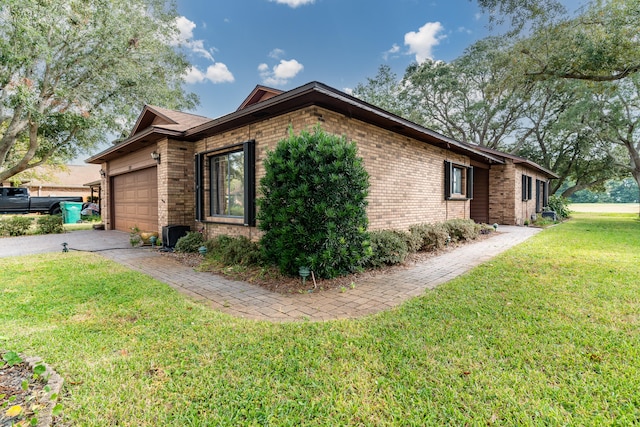 view of side of property with a garage and a yard