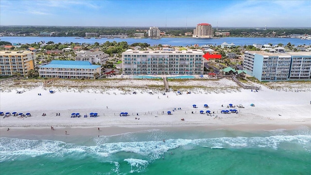 birds eye view of property with a view of the beach, a water view, and a city view