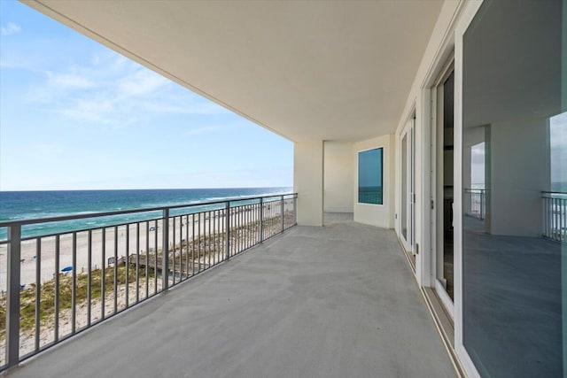 balcony with a water view and a beach view