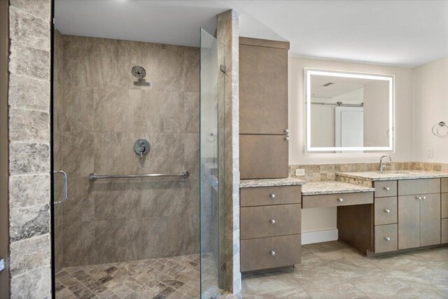 bathroom featuring a stall shower and vanity