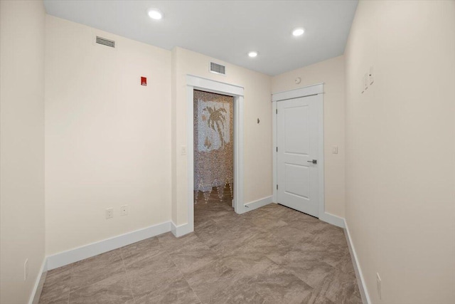 unfurnished room featuring recessed lighting, visible vents, and baseboards