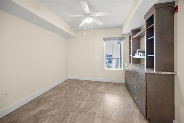 unfurnished bedroom with a ceiling fan and baseboards