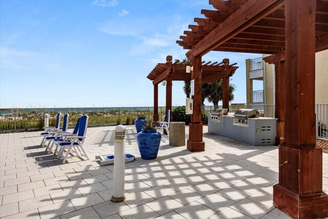 view of patio featuring an outdoor kitchen, a pergola, and area for grilling