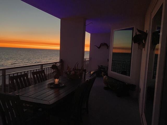 balcony with a water view and a beach view