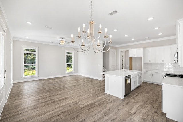 kitchen with appliances with stainless steel finishes, hardwood / wood-style floors, white cabinetry, crown molding, and a center island with sink