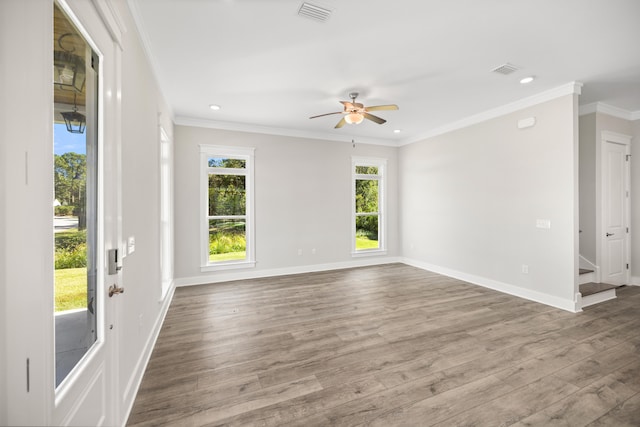 spare room featuring crown molding, hardwood / wood-style flooring, and ceiling fan