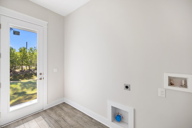 laundry area featuring light hardwood / wood-style floors, hookup for an electric dryer, a healthy amount of sunlight, and washer hookup