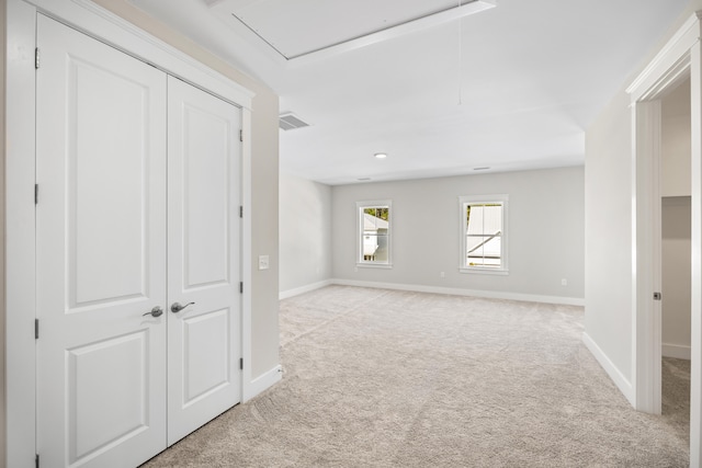 interior space featuring light carpet and a closet