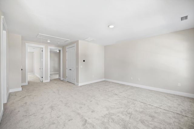 unfurnished room featuring light colored carpet