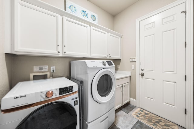 laundry room with cabinets and washing machine and dryer