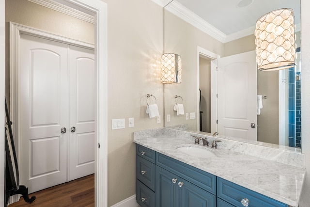 18 Spyglass Dr, Miramar Beach, FL 32550 - bathroom with ornamental molding, vanity, and wood finished floors
