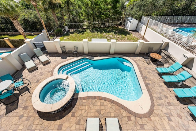 18 Spyglass Dr, Miramar Beach, FL 32550 - view of pool with a patio, a fenced backyard, a pool with connected hot tub, and view of wooded area