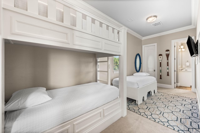 bedroom featuring connected bathroom, light carpet, and crown molding