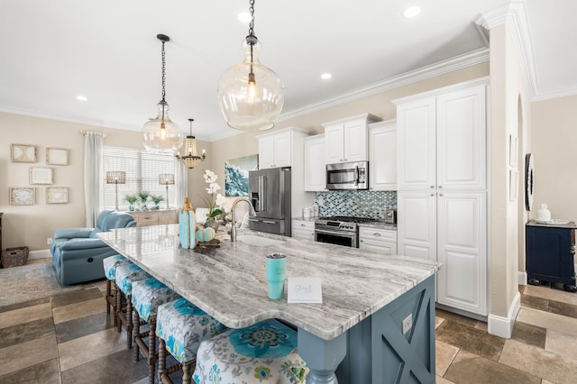 kitchen featuring a spacious island, white cabinets, premium appliances, and a kitchen bar