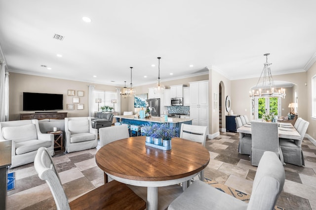 18 Spyglass Dr, Miramar Beach, FL 32550 - dining room featuring a chandelier, recessed lighting, arched walkways, crown molding, and light stone finish flooring