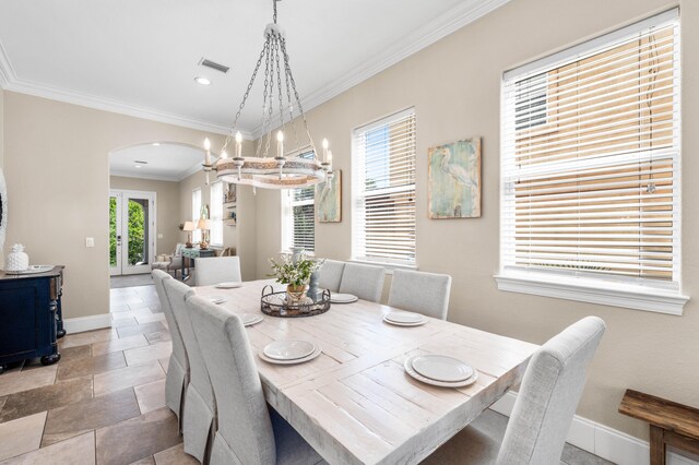 dining space featuring crown molding and a wealth of natural light