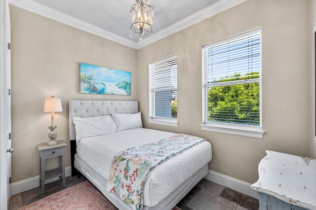 18 Spyglass Dr, Miramar Beach, FL 32550 - bedroom with crown molding and a chandelier