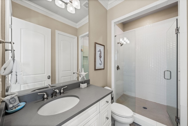 bathroom featuring vanity, crown molding, toilet, and walk in shower