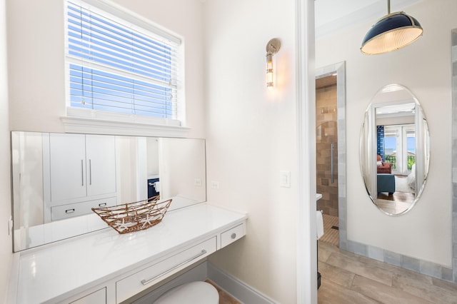 bathroom with vanity, tiled shower, and crown molding