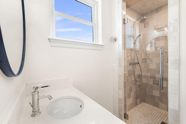 bathroom with vanity and a shower with shower door