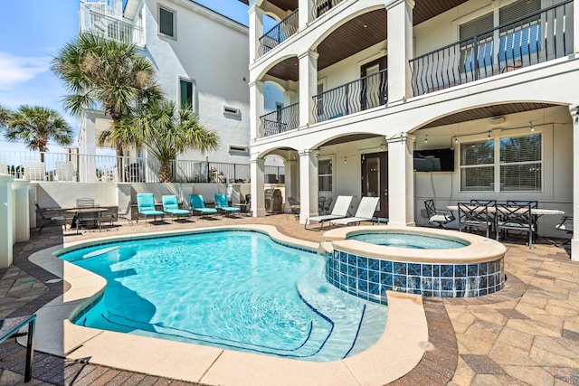 view of swimming pool with an in ground hot tub and a patio area