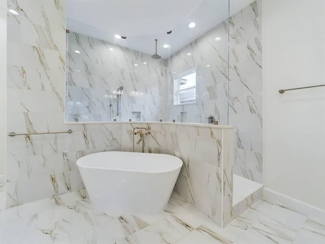 bathroom with tile walls and plus walk in shower