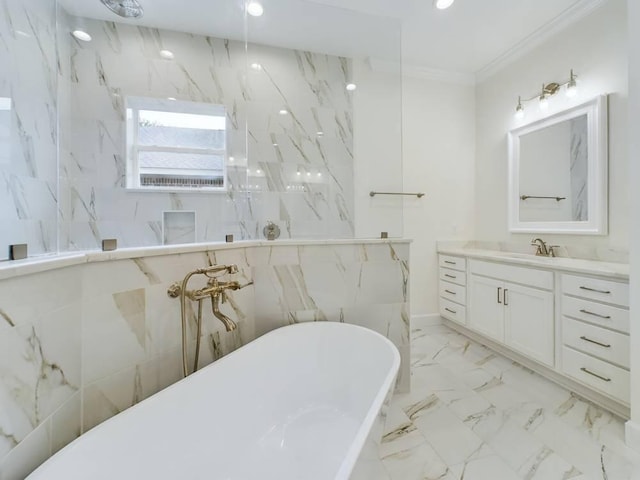 bathroom featuring ornamental molding, vanity, and a bathtub