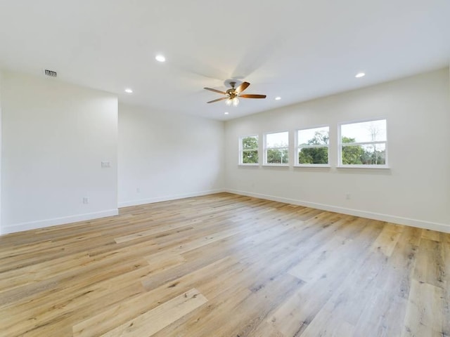 empty room featuring ceiling fan and light wood-type flooring