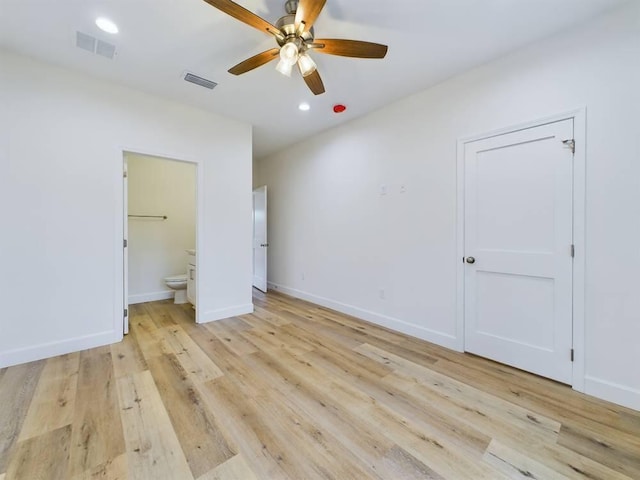 unfurnished bedroom featuring connected bathroom, ceiling fan, and light wood-type flooring