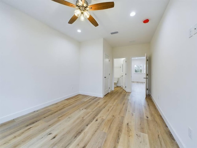 spare room with ceiling fan and light wood-type flooring