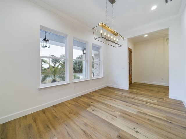 unfurnished dining area with ornamental molding and light hardwood / wood-style floors