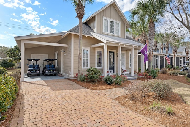 2448 Bungalo Ln, Miramar Beach, FL 32550 - view of front of house with covered porch, board and batten siding, decorative driveway, and a carport